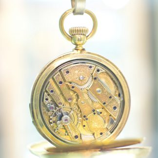Gold Pocket watch on light background.