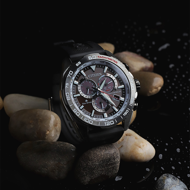 Traditional Citizen Watch over wet pebbles.